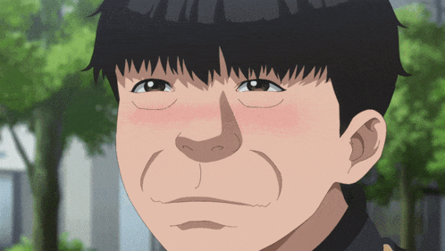 a close up of a man 's face with a slight smile on his face