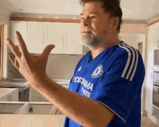 a man wearing a blue shirt that says yokohama tires