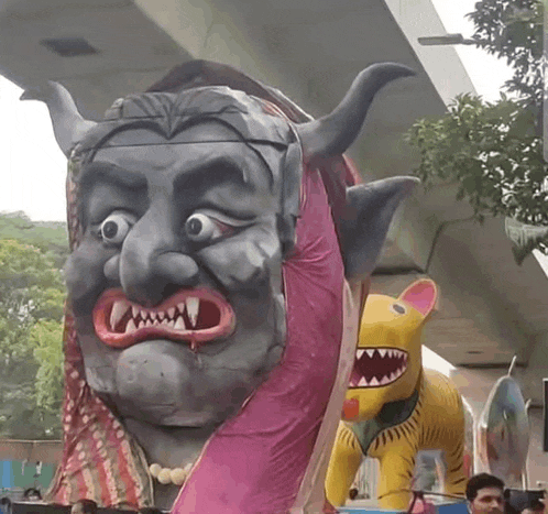 a statue of a woman with horns and a tiger with teeth