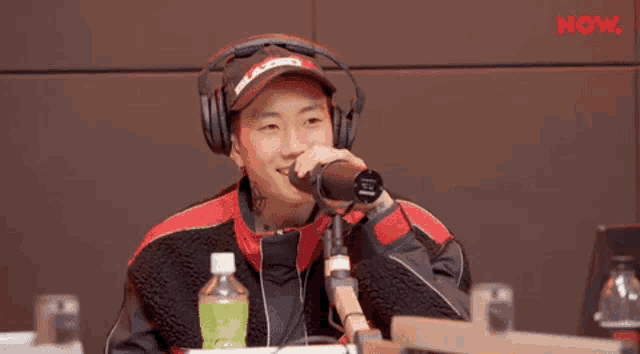 a man wearing headphones is singing into a microphone .