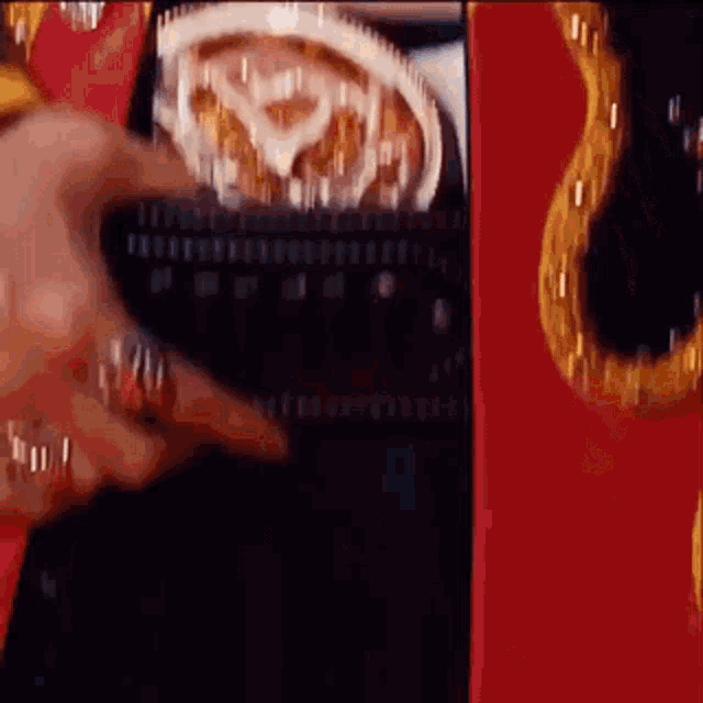 a close up of a person 's hand holding a belt with a ring on it .