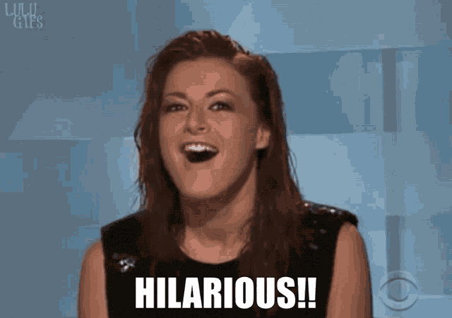 a woman with red hair is laughing with hilarious written on her face