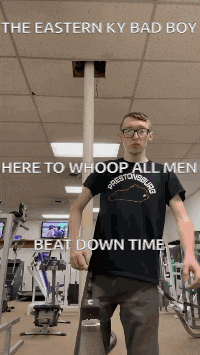 a man in a prestonsburgs shirt is standing in a gym