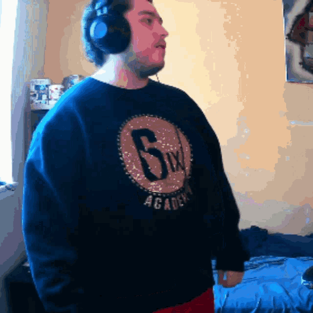 a man wearing headphones and a sweatshirt that says 6ix academy