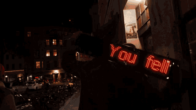 a person holding a sign that says " i love again "
