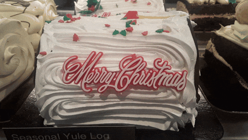 a cake that says merry christmas is on display