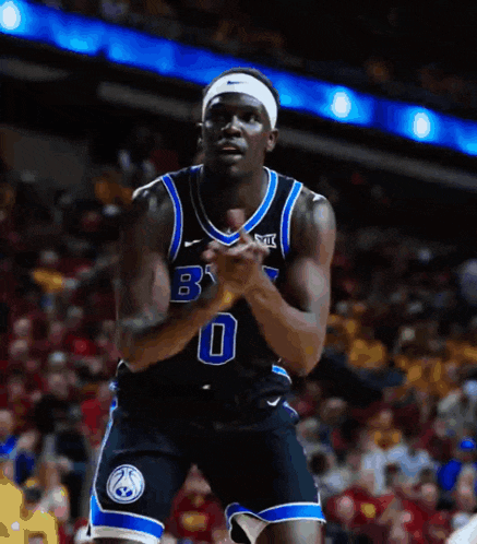 a basketball player with the number 0 on his jersey stands on the court