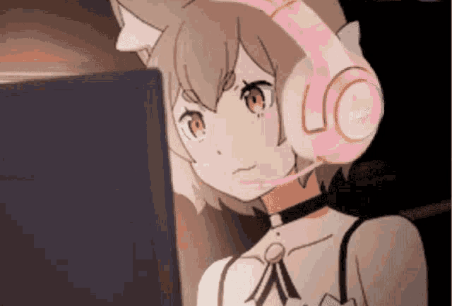 a girl wearing pink headphones is looking at a laptop computer .