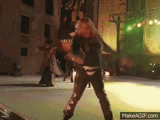 a man is dancing on a stage with a makeagif.com watermark
