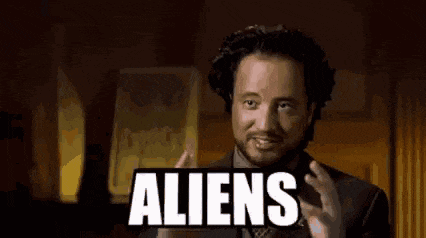 a man with a beard is holding a sign that says aliens .