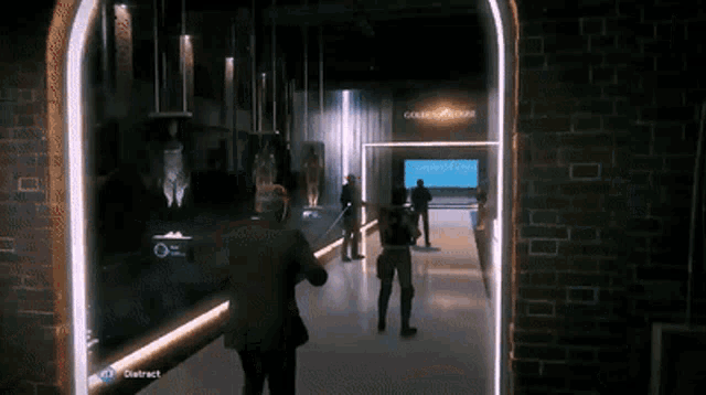 a group of people are standing in a hallway with a sign that says ' golden bridge ' on it