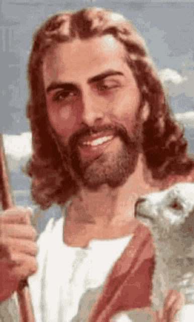 jesus is smiling while holding a sheep in his arms .