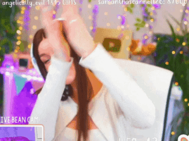 a woman is sitting in front of a computer with the words i 've bean cam in the lower right corner