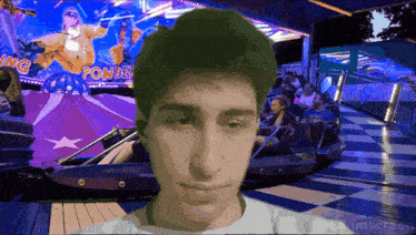 a man in front of a roller coaster that says powder