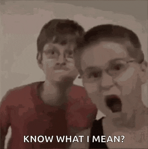 two boys are standing next to each other with their mouths open and one of them is asking the other what he means .