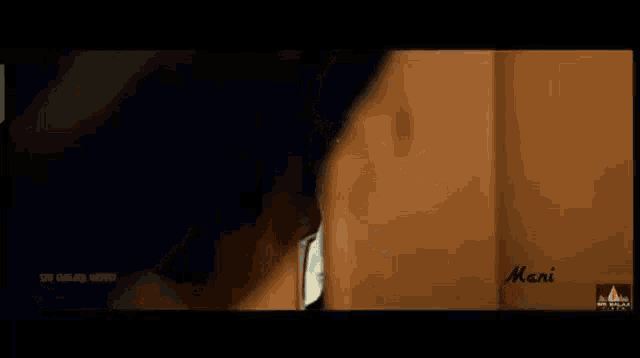 a man is peeking out from behind a door in a movie .