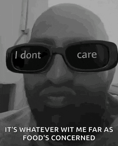 a bald man wearing sunglasses with the words `` i dont care '' written on them .