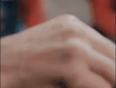 a close up of a person 's hand with a ring on their finger .