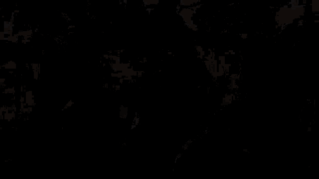 a pixelated image of a man holding a gun with a glowing object in the background