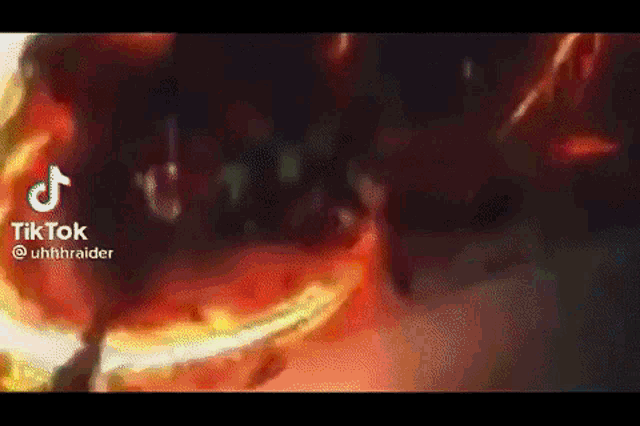 a close up of a person holding a sword in front of a fireball .