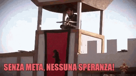 a man is holding a gun in a tower with the words senza meta nessuna speranza