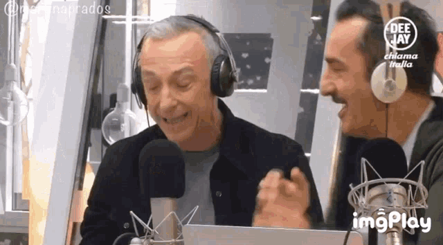 two men wearing headphones are talking into microphones in a radio station .