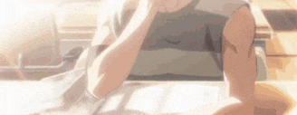 a close up of a person sitting at a table with a book .