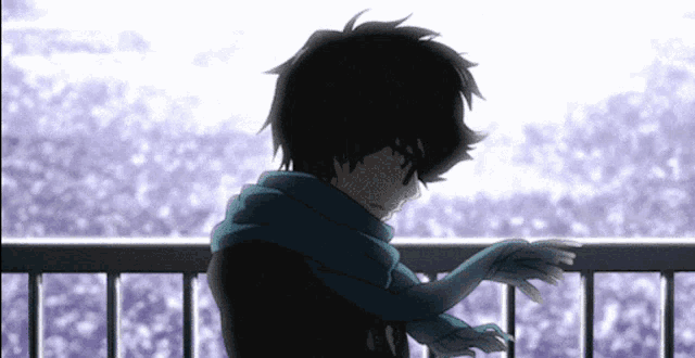 a person with a scarf around their neck stands on a balcony