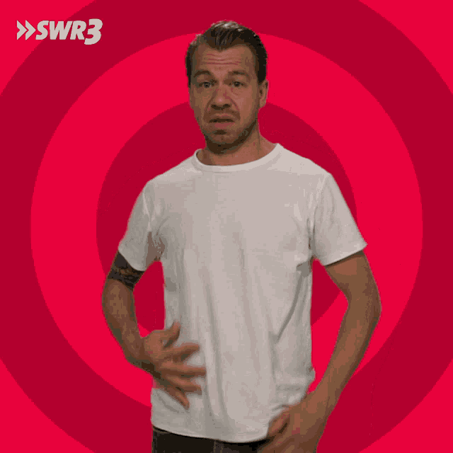 a man in a white shirt is standing in front of a red circle with swr3 on the bottom