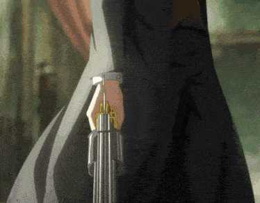a person holding a gun in their hand with a gold ring around it
