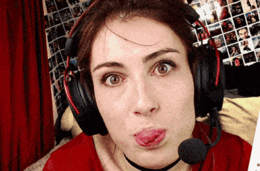 a woman wearing headphones and a microphone making a face
