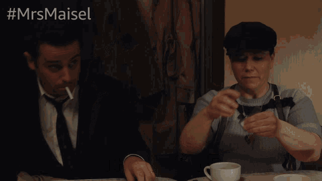 a man lighting a cigarette next to a woman who is saying [ mouthing silently ]