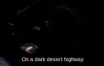 a man is playing drums in front of a microphone with the words on a dark desert highway above him .