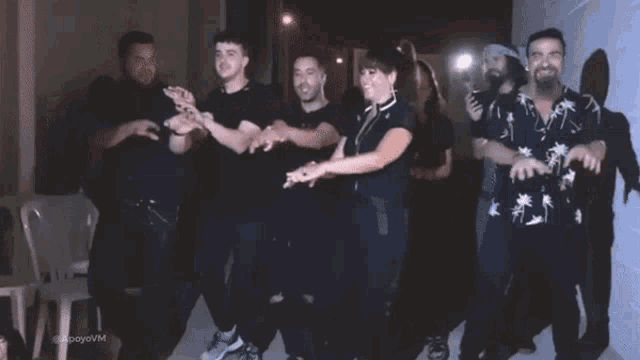 a group of people are dancing in a hallway with a watermark that says ' alonsoevm ' on it