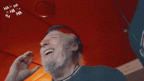 a man with a beard and headphones is laughing with ha ha ha ha written around him