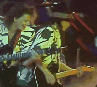 a man playing a guitar with the number 21 on his shirt