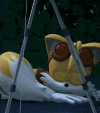 a stuffed animal wearing goggles is laying under a tent