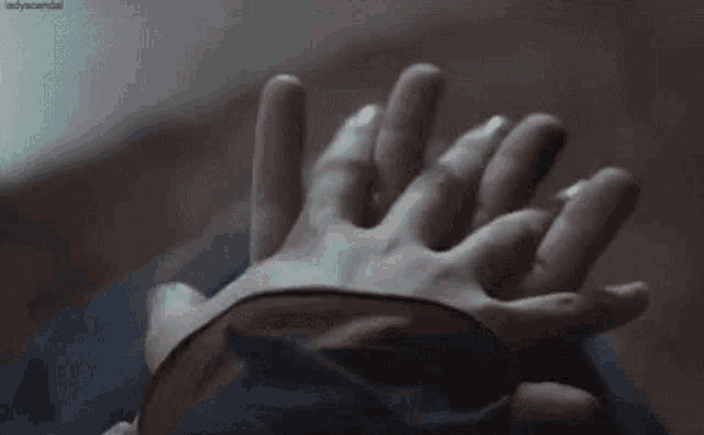 a person is holding another person 's hand in their underwear .