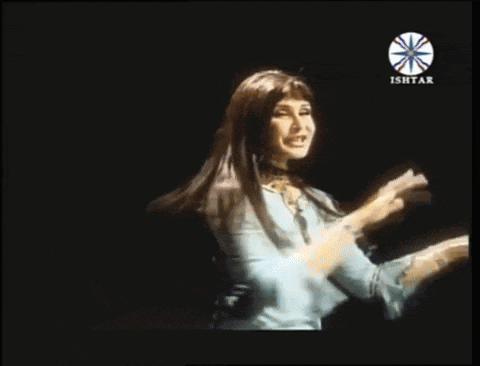 a woman singing in front of a logo for ishtar
