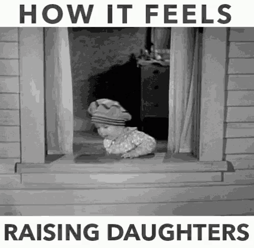 a black and white photo of a child looking out of a window with the words how it feels raising daughters below it