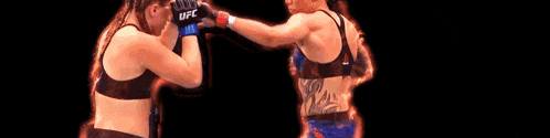 two women are boxing and the word boo is in the foreground