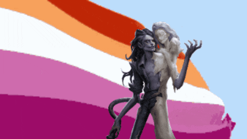 a statue of a man and a woman standing in front of a rainbow flag