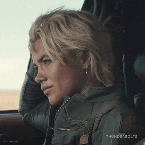 a woman is sitting in a car with thunderbolts written on the bottom