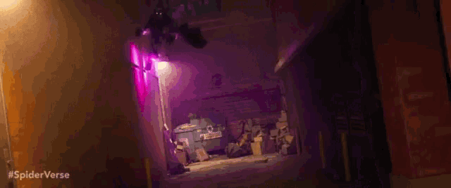 a person is flying through the air in a dark alleyway with purple lights .