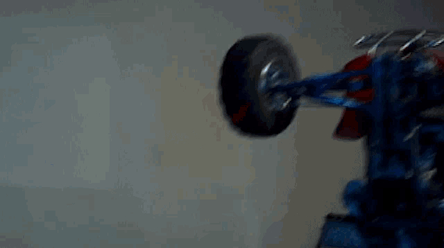 a person is doing a trick on a atv in a dark room .