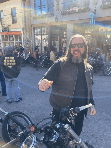 a man on a motorcycle wearing a jacket that says i was there the day my man killed a person