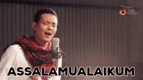 a man singing into a microphone with the words assalamualaikum written on the screen