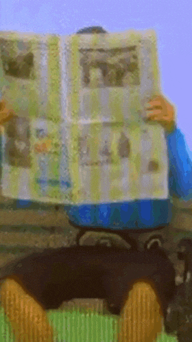 a person is reading a newspaper with a picture of a dog on it