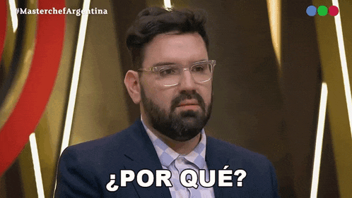 a man with glasses and a beard is asking " por que "