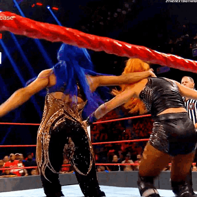 two women are wrestling in a ring with a referee and the word case on the bottom right